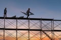 Man working on construction site with scaffold and building with sunset background,scaffolding for construction factory Royalty Free Stock Photo