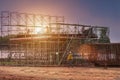 Man working on construction site with scaffold and building with sunset background,scaffolding for construction factory Royalty Free Stock Photo