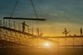 Man working on construction site with scaffold and building with sunset background,scaffolding for construction factory Royalty Free Stock Photo