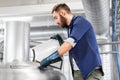 Man working at craft brewery or beer plant Royalty Free Stock Photo