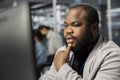 Man working in data center analyzing software logs metrics on PC Royalty Free Stock Photo