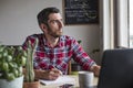 Man working at desk thinking about ideas and looking out of window Royalty Free Stock Photo