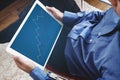 A man working on digital tablet, business raising graph on screen. Success investment and business growth Royalty Free Stock Photo