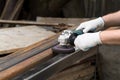 A man working with electric angle grinder tool. Removing rust. Hands in white gloves ho Royalty Free Stock Photo