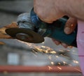 Man working with electric grinder tool on steel pipe Royalty Free Stock Photo