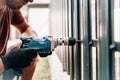 Caucasian man working with an electric screwdriver on the construction site Royalty Free Stock Photo