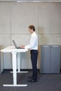 Man working at electrically controlled height adjustment table