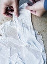 Man working with fabric soaked in wet plaster