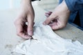 Man working with fabric soaked in wet plaster