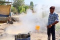 Man working in a factory boiling sugar cane.