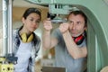 man working with female apprentice in factory Royalty Free Stock Photo