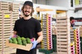 Man working at fruit warehouse carrying avocados Royalty Free Stock Photo