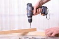 Man is working with furniture assembly using electric screwdriver in new house installation - technician onsite work using hand Royalty Free Stock Photo
