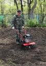 Man working in the garden preparing ground cultivator