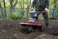 Man working in the garden preparing ground cultivator