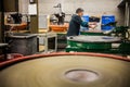 Man Working a Glass Blown Vase on Silica Sanding Disk Royalty Free Stock Photo