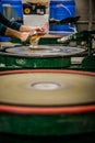 Man Working a Glass Blown Vase on Silica Sanding Disk Royalty Free Stock Photo