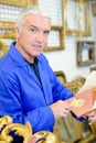 Man working with gold leaf