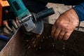 Man working with grinder saw, close up view on tool. Electric saw and hands of worker with sparks Royalty Free Stock Photo