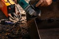 Man working with grinder saw, close up view on tool. Electric saw and hands of worker with sparks. Royalty Free Stock Photo