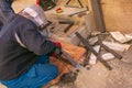 Man working with grinder saw, close up view on tool. Electric saw and hands of worker with sparks. Worker cutting metal with Royalty Free Stock Photo