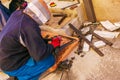 Man working with grinder saw, close up view on tool. Electric saw and hands of worker with sparks. Worker cutting metal with Royalty Free Stock Photo