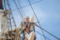 Man working at heights on a sailboat mast Royalty Free Stock Photo