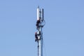 MILAN, ITALY 4 MAY 2019.: man working on high tower or pole of telecommunication. Working with high risk. Maintenance on Royalty Free Stock Photo