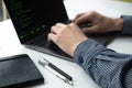 Man working on his computer. Man`s hands with laptop on white table
