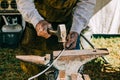 Man working with his hands on with a metal hammer