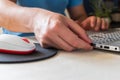 Man working on his laptop, inserting a USB nano receiver for mouse connectivity