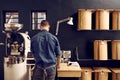 Man working in his modern coffee roastery with neat storage Royalty Free Stock Photo