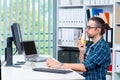 Man is working in his office and eating banana