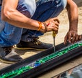 A man working with his screwdriver tool