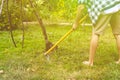 Man working with hoe in garden under tree on lawn a Royalty Free Stock Photo