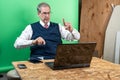 Man working from home in his basement on a virutal meeting. Royalty Free Stock Photo