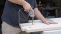 A man working on a home improvement project drilling into wood. Royalty Free Stock Photo