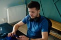 Bored man playing smartphone while working at home office Royalty Free Stock Photo