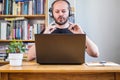 Man working from home office, on teleconference