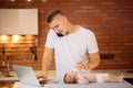 Man working from home and taking care of baby Royalty Free Stock Photo