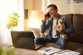 Man working from home talking on phone with his dog