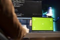 Man working from home using green screen laptop, testing and deploying programs Royalty Free Stock Photo