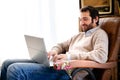 Man working at home using his laptop Royalty Free Stock Photo