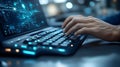 Man working on innovative laptop with futuristic interface and glowing keyboard Royalty Free Stock Photo