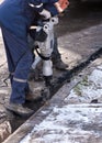 Man working a jackhammer on a city street Royalty Free Stock Photo