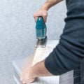 Man working with jigsaw on white laminate