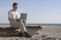 Man working with laptop on beach Royalty Free Stock Photo