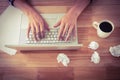 Man working on laptop by black coffee at desk in office Royalty Free Stock Photo