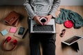 Man working with laptop computer and hand hoding cup of coffee