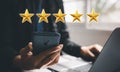 Man working with laptop computer and using smart mobile phone to feedback five star 3D icon
